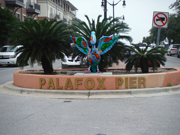 Palafox Pier sign and a painted pelican
